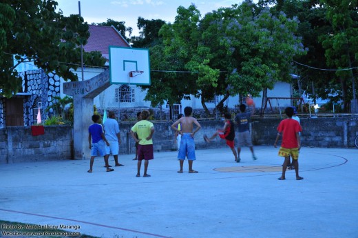 Teenagers playing at the Basketball Court