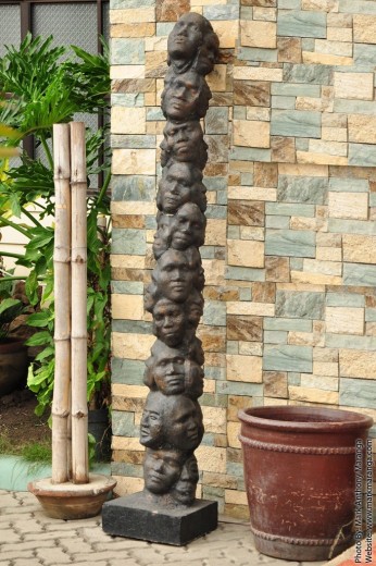Hand-made wood carving of many faces