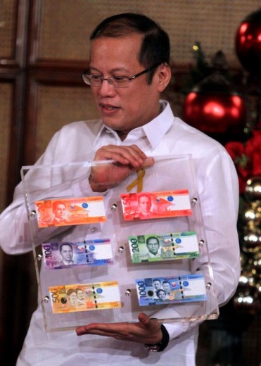 President Aquino showcasing the new bills
