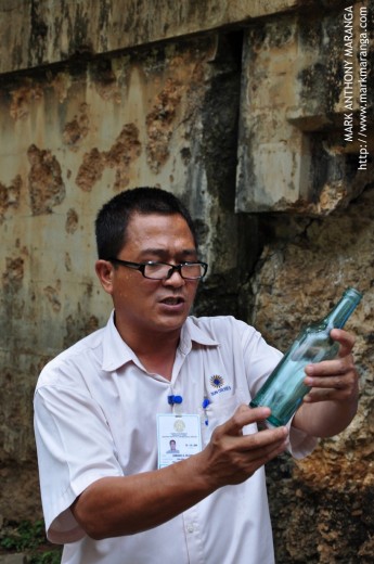 Armand (Tour Guide) Showing an Old Coca Cola Bottle