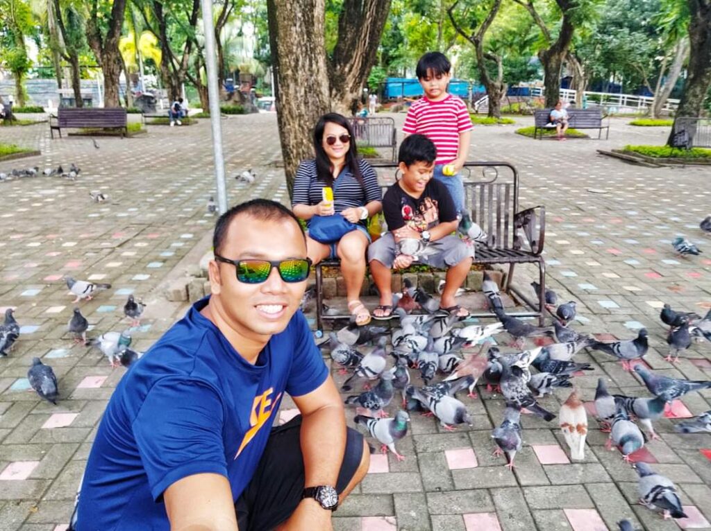 Feeding the doves in Davao Park