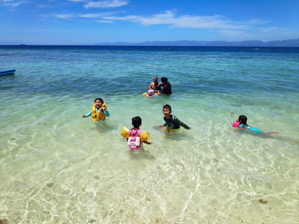 Kids enjoying the crystal clear waters
